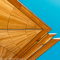 Buy canvas prints of Abstract view of roof structure against blue sky.  by Paul Tuckley