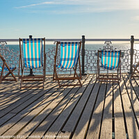 Buy canvas prints of Empty deckchairs on Brighton Pier by Marcin Rogozinski