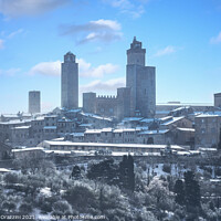 Buy canvas prints of San Gimignano town skyline after a snowfall. Tuscany, by Stefano Orazzini