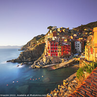 Buy canvas prints of Riomaggiore town, cape and sea at sunset. Cinque Terre, Liguria, by Stefano Orazzini