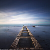 Buy canvas prints of Wooden pier remains in a blue sea. Long Exposure. by Stefano Orazzini