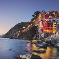 Buy canvas prints of Riomaggiore town, cape and sea at sunset. Cinque Terre, Liguria, by Stefano Orazzini