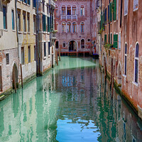 Buy canvas prints of Calm  Quiet Canal in Venice Italy by John Gilham