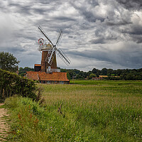 Buy canvas prints of Outdoor field with a windmill under dramatic stormy sky by John Gilham