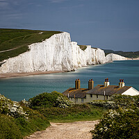 Buy canvas prints of The Seven Sisters cliffs and the Coastguards Cottages at Cuckmere Haven near Eastbourne in East Sussex UK by John Gilham
