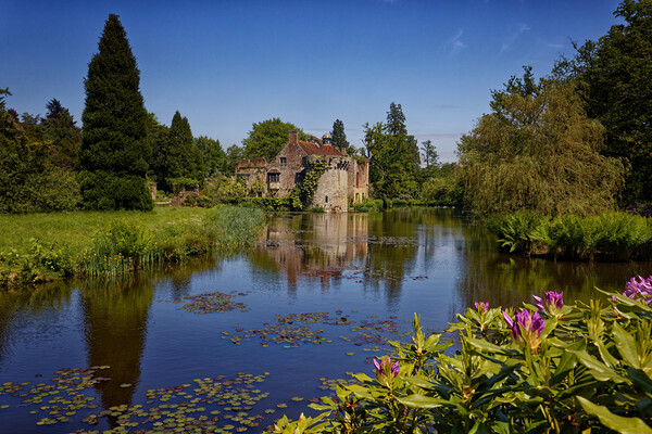 Reflections of the folly in the moat of Old Scotney Castle Lamberhurst Kent UK Picture Board by John Gilham