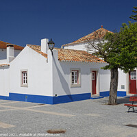 Buy canvas prints of White Portuguese cottages with deep blue sky by Dudley Wood