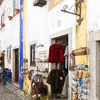 Buy canvas prints of Charming Souvenir Shop in Obidos by Dudley Wood