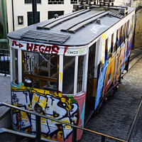 Buy canvas prints of Graffiti on Lisbons Funicular Tram by Dudley Wood