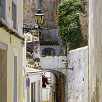 Buy canvas prints of The Enchanting Elvas Street by Dudley Wood