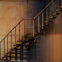 Buy canvas prints of Golden glow on metal stairs outside an industrial  by Errol D'Souza