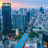 Buy canvas prints of The Cityscape, the Railway of the Skytrain and the skyscraper of Bangkok in Thailand Southeast Asia at the Evening by Wilfried Strang