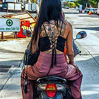 Buy canvas prints of a young tattooed Thai woman on a motorcycle by Wilfried Strang