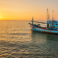Buy canvas prints of  A fishing boat at a pier in the early evening during sunset time by Wilfried Strang