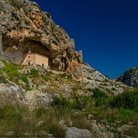 Buy canvas prints of Lovely chapel inside a Cave in a green valley of M by Maggie Bajada