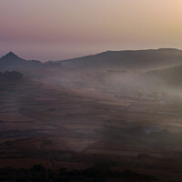 Buy canvas prints of Early morning sunrise with mist all over the fields in Gozo, Malta.  by Maggie Bajada