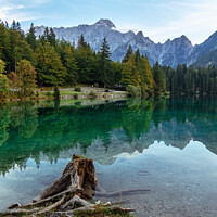Buy canvas prints of Picturesque Blue Lake Fusine with Julian Alps in Background. by Maggie Bajada