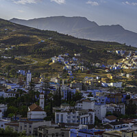 Buy canvas prints of Wonderful Blue City with Mountains of Chefchoueon, Morocco by Maggie Bajada
