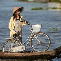 Buy canvas prints of Bicycle and Girl on a WaterTaxi, Vietnam by Ian Miller