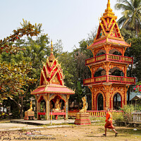 Buy canvas prints of Buddhist Building with a Monk by Ian Miller