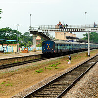 Buy canvas prints of Train at a rural railway station by Lucas D'Souza