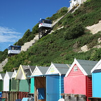 Buy canvas prints of Charming Pastel Beach Huts by Roger Mechan