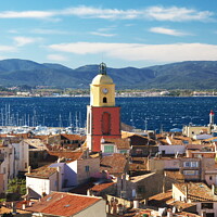 Buy canvas prints of St Tropez's Red Roofs and Colourful Church by Roger Mechan