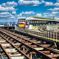 Buy canvas prints of Departing Ryde: A Train and its Solent Scenery by Roger Mechan