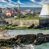 Buy canvas prints of Conical Towers Rise Over Serene Coastal Town by Roger Mechan