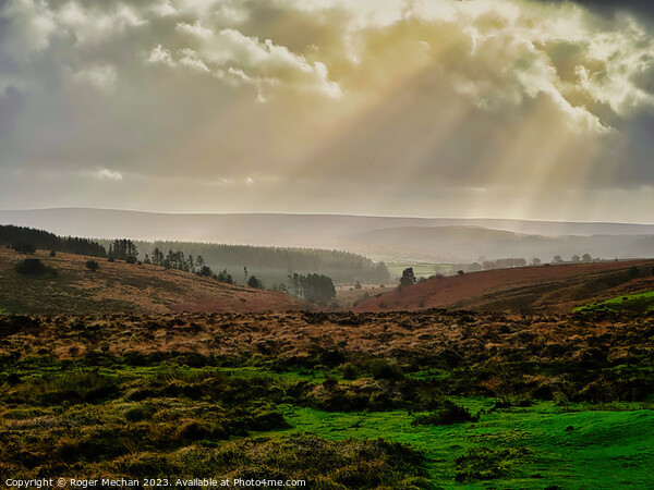 Autumn rays over Dartmoor. Picture Board by Roger Mechan
