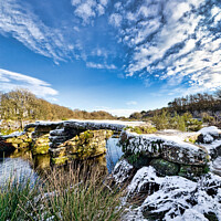Buy canvas prints of Dartmoor clapper bridge in the snow by Roger Mechan