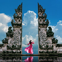 Buy canvas prints of Young woman standing in temple gates at Lempuyang Luhur temple  by Stan Lihai