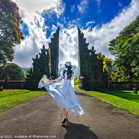 Buy canvas prints of Woman walking at big entrance gate, Bali in Indonesia by Stan Lihai