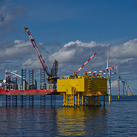 Buy canvas prints of Offshore jackup installing turbine blades by Russell Finney