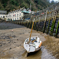 Buy canvas prints of Clovelly Harbour Wall and Fishing Boat by Stuart Wyatt