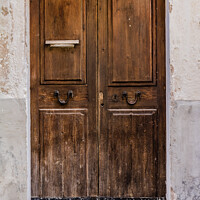Buy canvas prints of Weathered old brown wooden front door by Alex Winter