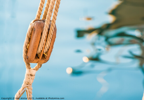Nautical pulley with ropes of a classic sailing boat and blue sea water background Picture Board by Alex Winter
