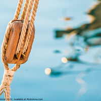 Buy canvas prints of Nautical pulley with ropes of a classic sailing boat and blue sea water background by Alex Winter