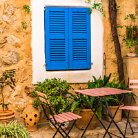 Buy canvas prints of patio house with blue window shutters by Alex Winter