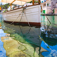 Buy canvas prints of Idyllic view of old fisher boat at Cala Figuera by Alex Winter