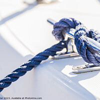 Buy canvas prints of Detail view of blue nautical rope cleat on boat de by Alex Winter