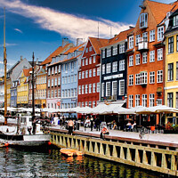 Buy canvas prints of Nyhavn Copenhagen colourful houses with cafes and people alongside canal with boats. by Ann Mechan