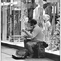 Buy canvas prints of Christmas Street Busker by Gareth Parkes