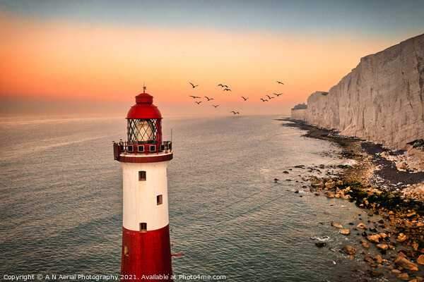 Beachy Head lighthouse at sunrise Picture Board by A N Aerial Photography