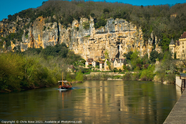 A sightseeing boat passes La Roque-Gageac Picture Board by Chris Rose