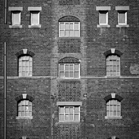 Buy canvas prints of Brick wall and windows pattern by Chris Rose