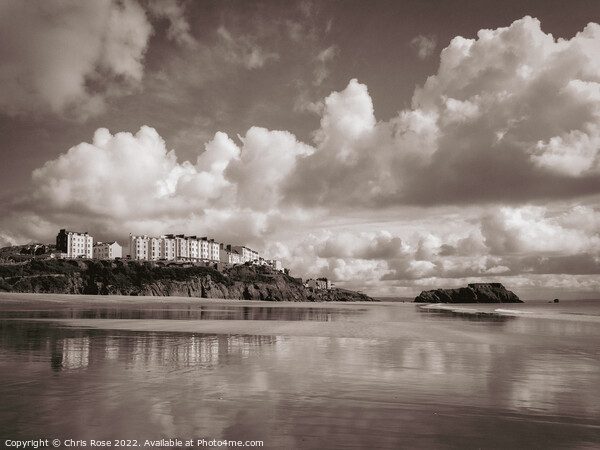 Tenby reflected in the wet sand of South Beach Picture Board by Chris Rose