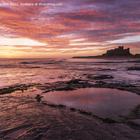 Buy canvas prints of Fiery Sunrise Over Bamburgh Castle by Steven Nokes