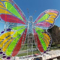 Buy canvas prints of Close Up of Stained Glass Butterfly Sculpture, Tir by Elaine Anne Baxter