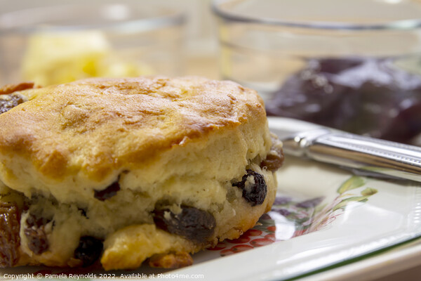 Freshly Baked Fruit Scone with Fresh Butter and Jam in the background Picture Board by Pamela Reynolds